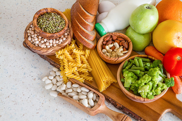 A collection of healthy food, including beans and chickpeas, spread out on a table