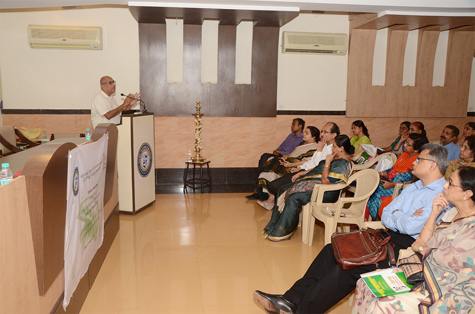 A presenter at Mumbai's 'Know Your Pulses-2016' One Day National Conference stands at the podium, the audience is seen listening
